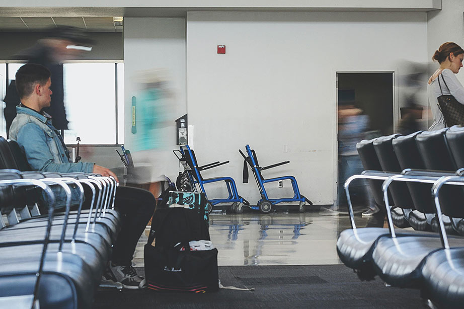 man waiting on airport due to flight delay