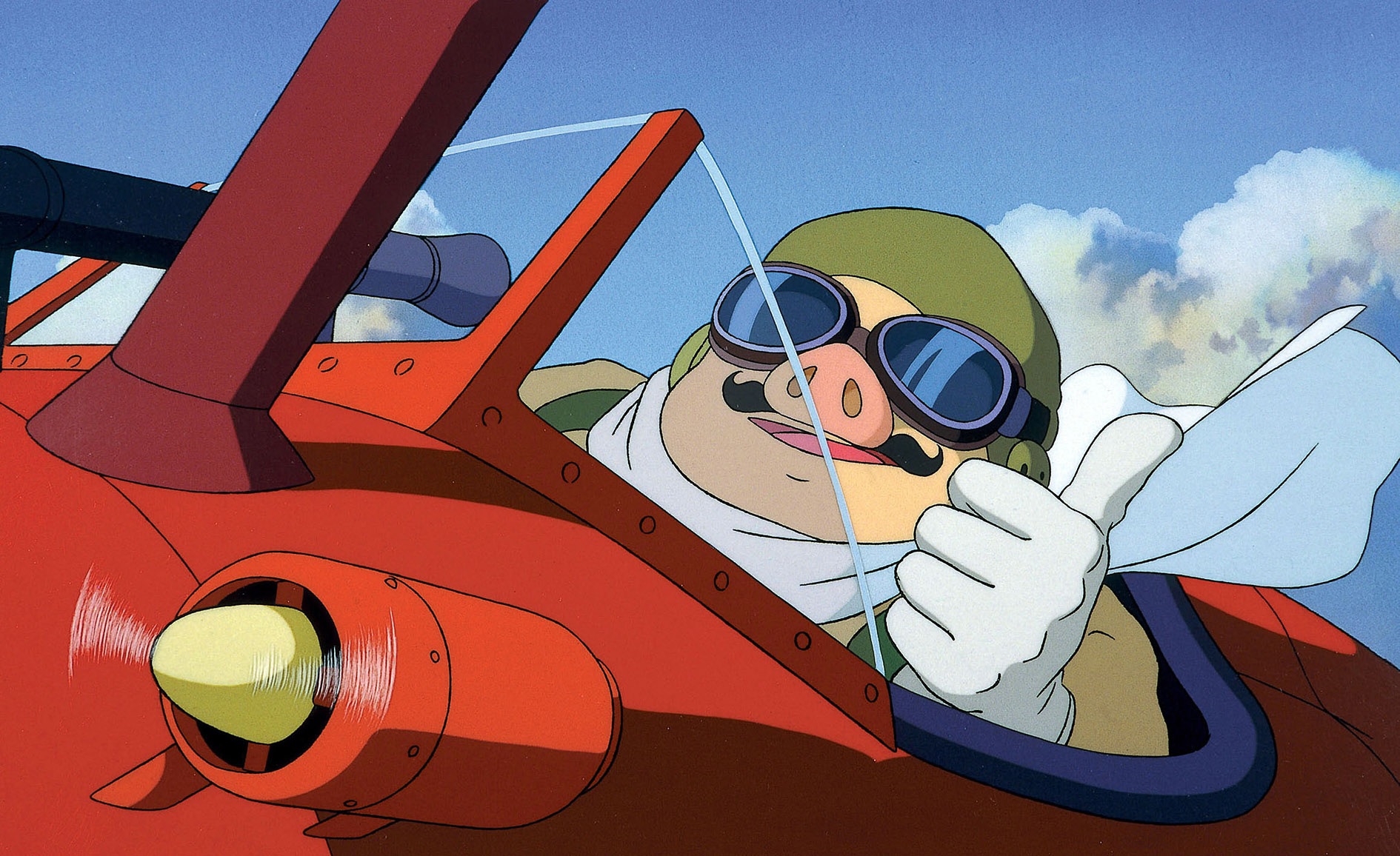 Porco Rosso flies through the skies in his red plane.