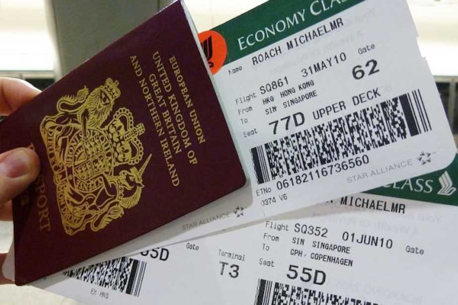 hand holding boardingpasses and UK passport