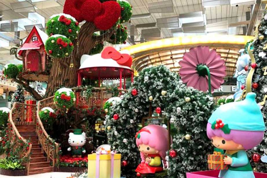 christmas decorations at changi airport with anime figures and hello kitty in front of a gazebo and treehouse