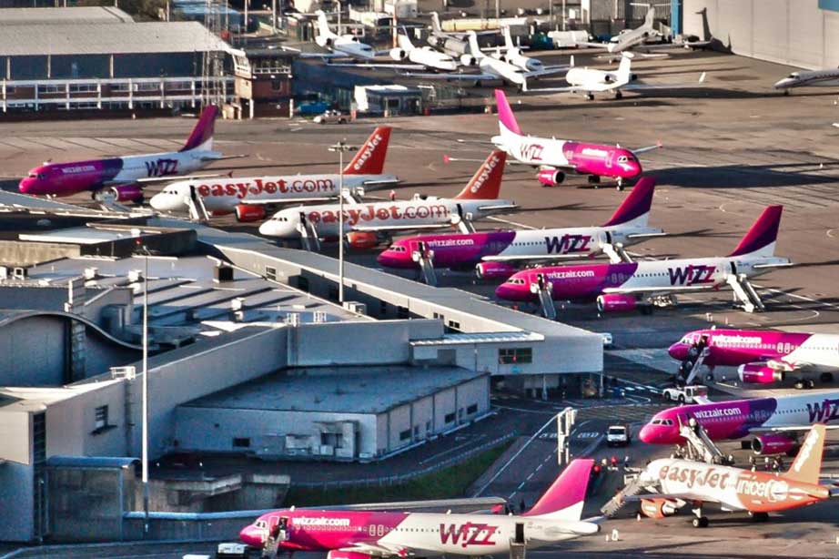 wizzair and easyjet planes at tarmac london luton airport