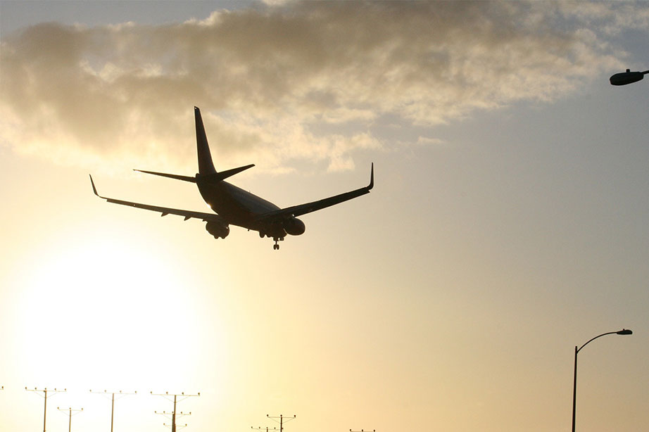 airplane in the air at sunrise