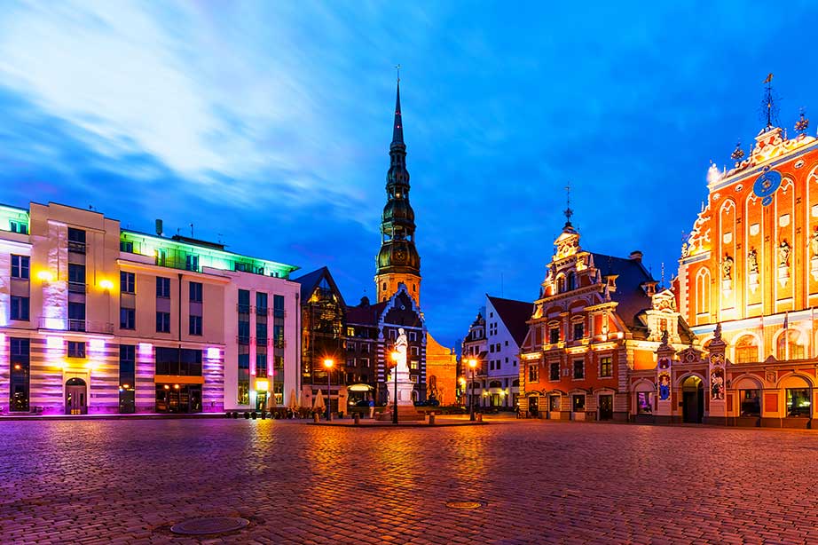 avond op plein in riga met verlichting en blauwe lucht