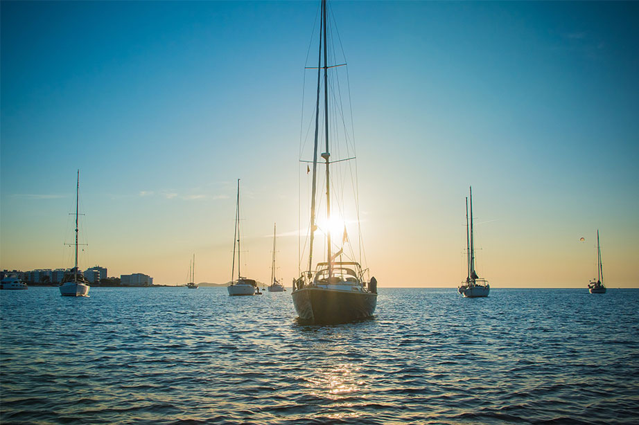 boats on water by sunset