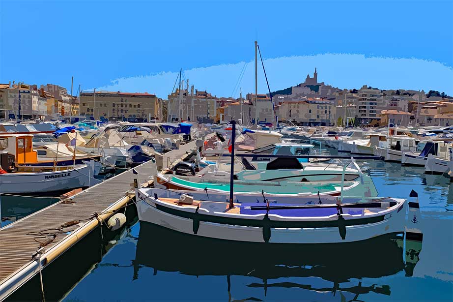 boats in Marseille harbour by docks and a blue sky on the background with the cityview