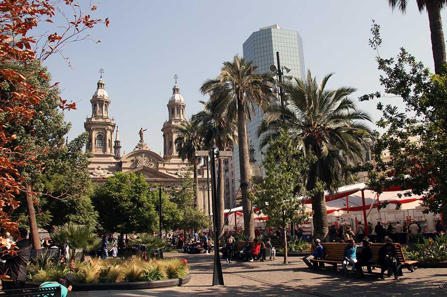 square in chile with palmtrees marketstands and church