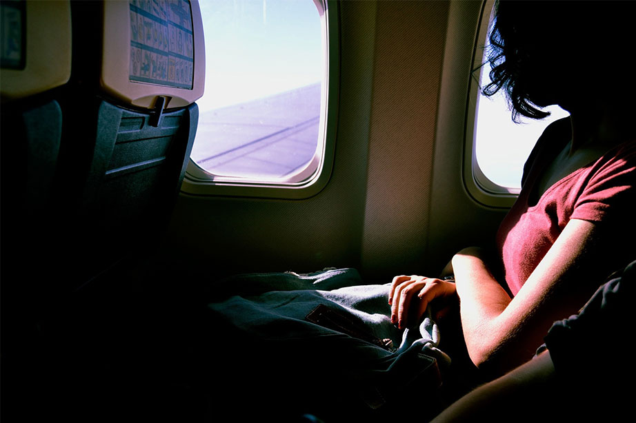 woman in plane looking out the window