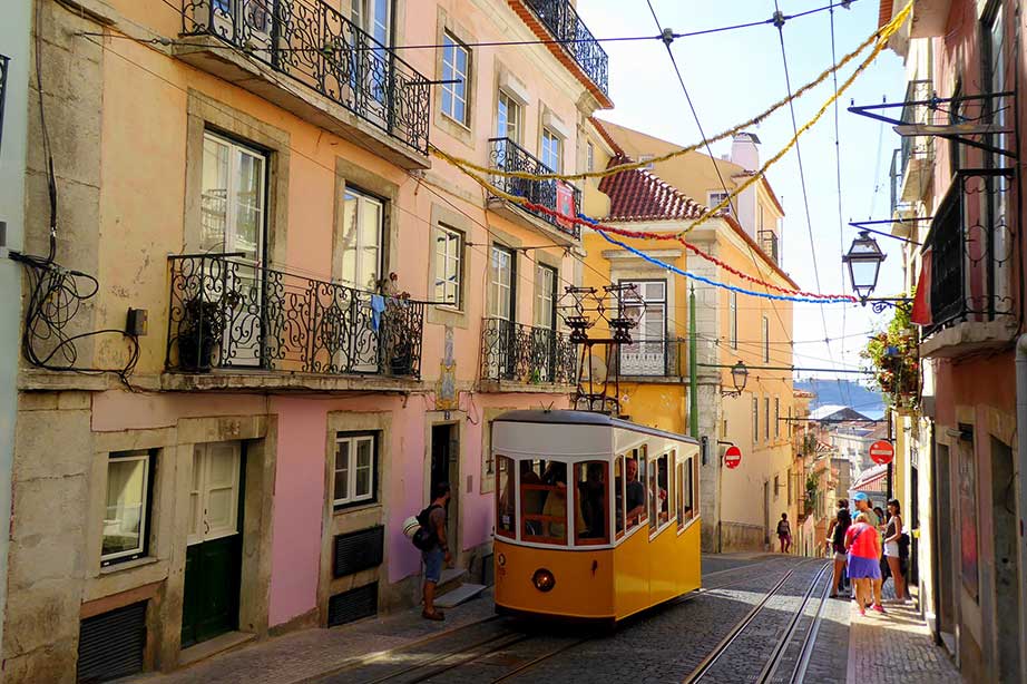 tram in lisbon with coloured houses