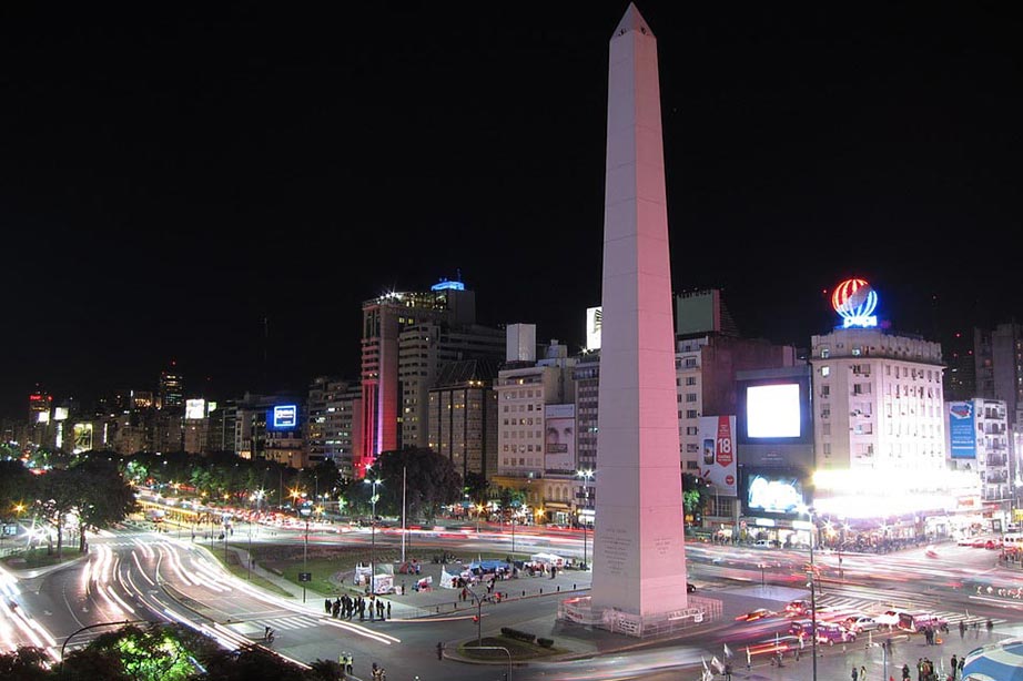 Obelisk of Buenos Aires during night time under dark blue sky and city lights