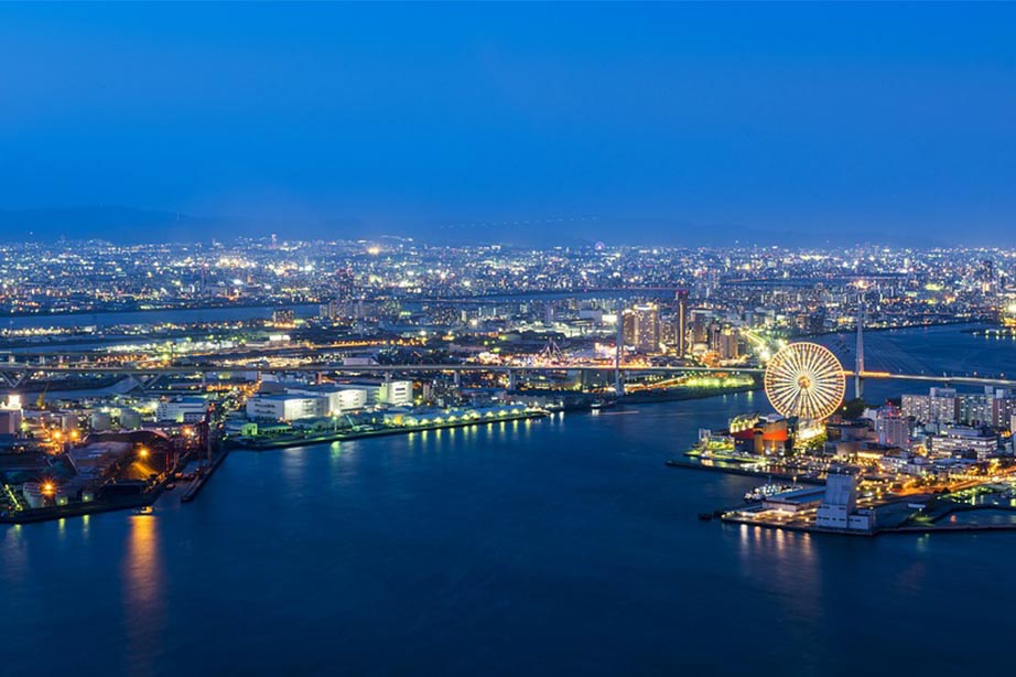 Port of Osaka by night with dark blue sky and city lights