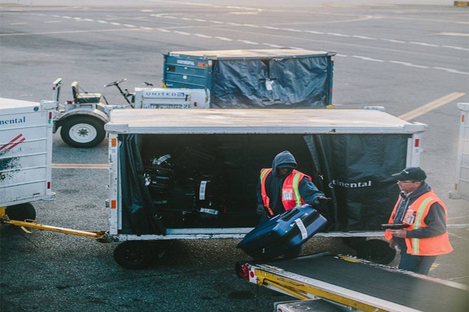 Baggage claim workers offloading luggage