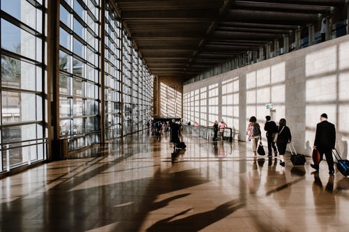 People walking through the airport finding departure gates