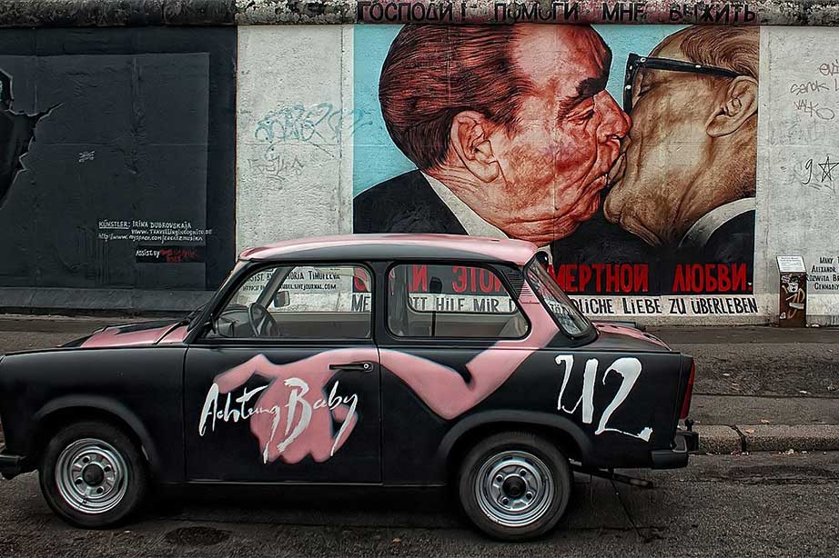 berlin wall mural with taxi in front