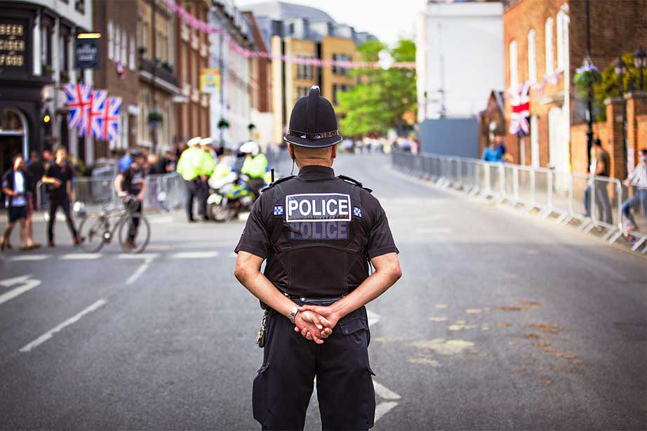 Police officer in the london streets with union jacks