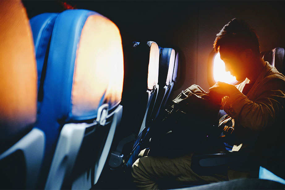 man on the plane with his backpack