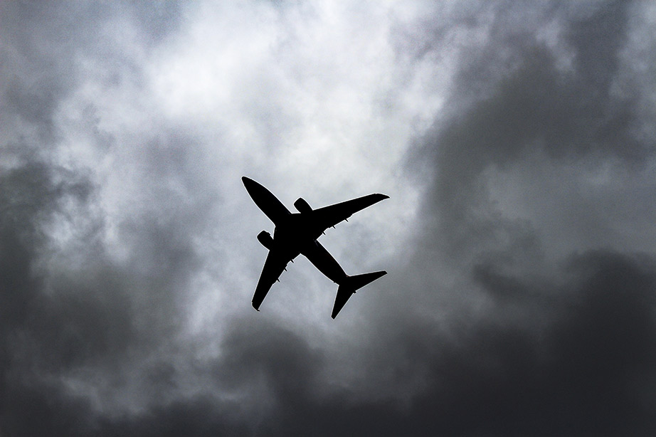 airplane flying in a dark cloud