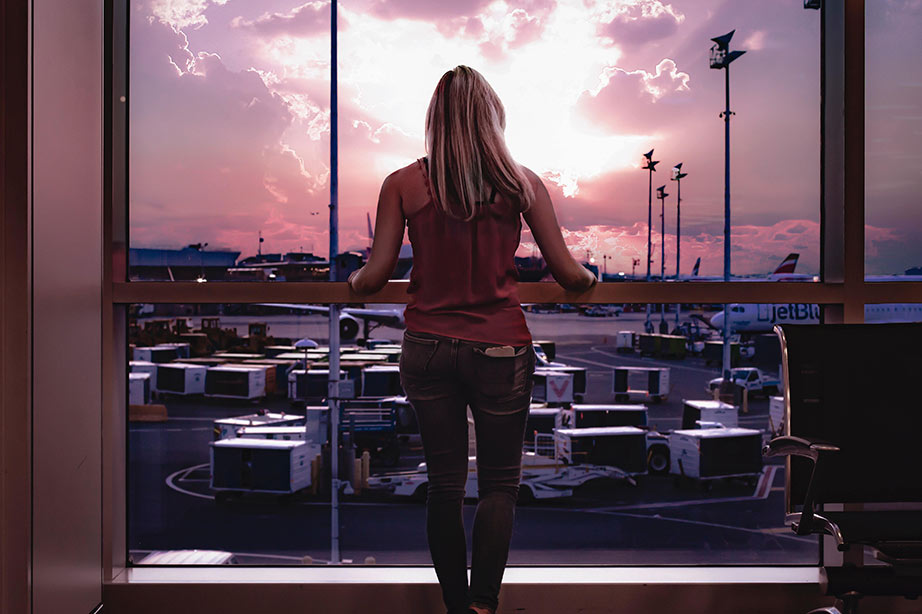 lady looking outside while waiting on airport