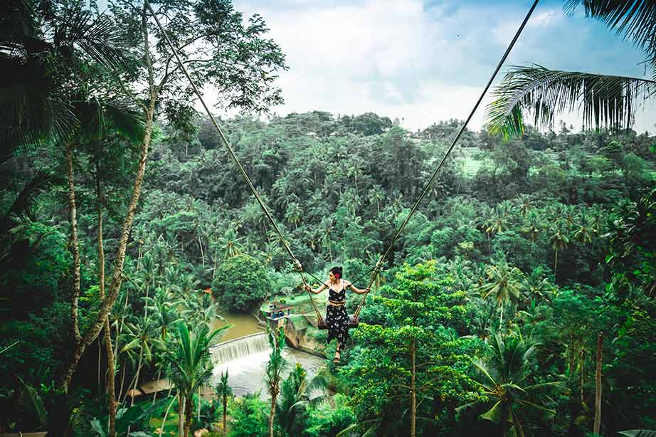 lady on swing in green jungle