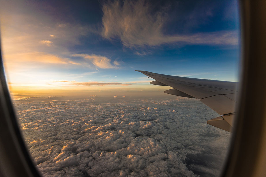 plane above the clouds during sunrise