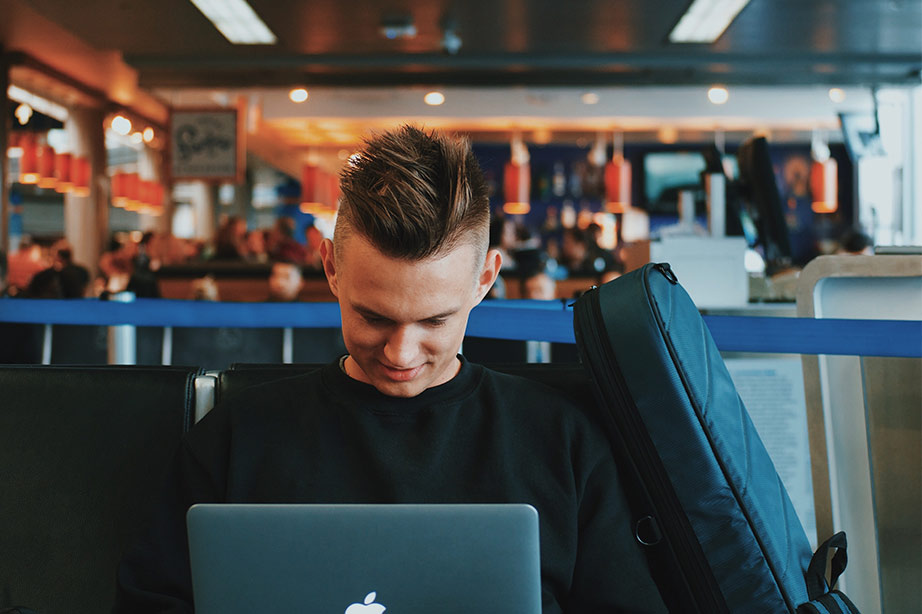 waiting man with laptop at airport