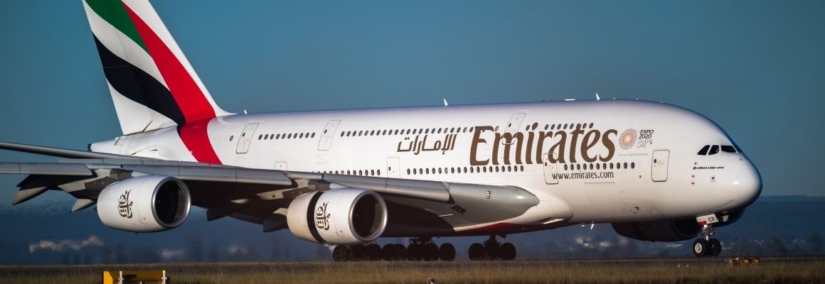 An Emirates Airbus A380 taxiing on the runway in daylight, with its engines and tail fin clearly visible.